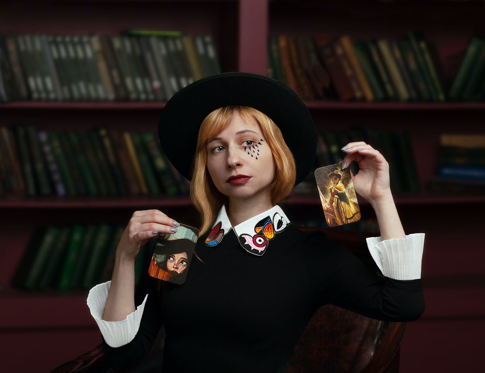 stylish young woman showing focus with cards