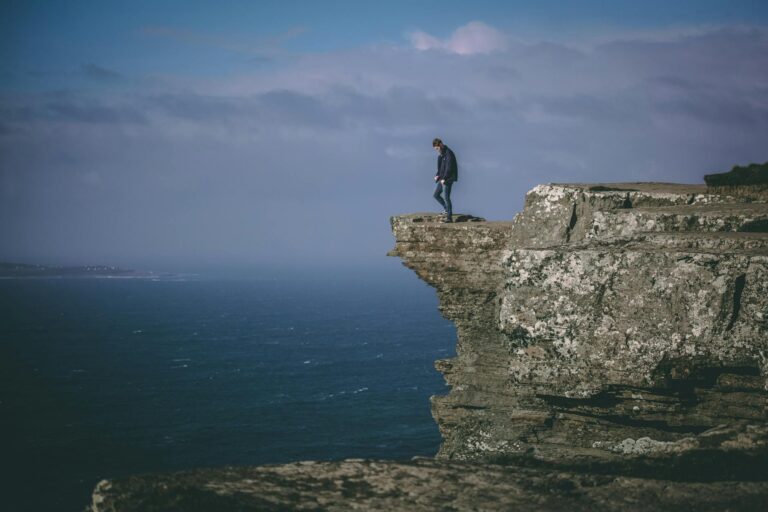 man standing on cliff